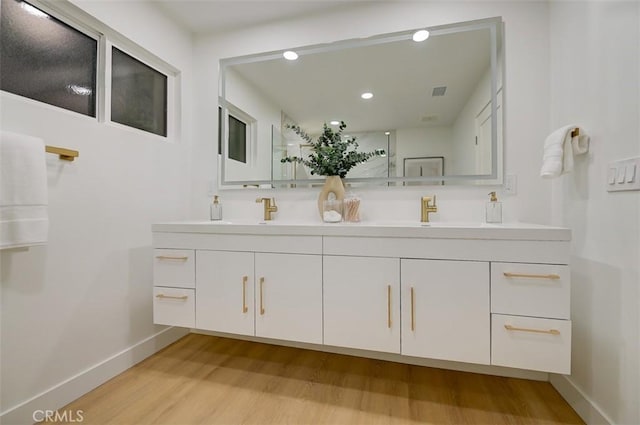 bathroom featuring vanity and hardwood / wood-style floors