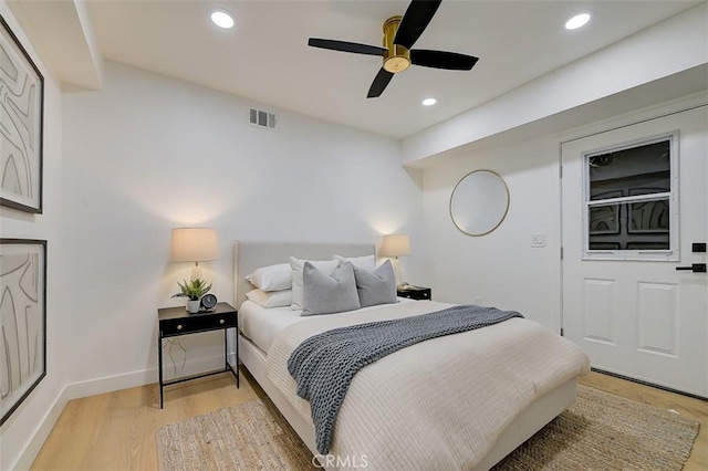 bedroom featuring light wood finished floors, baseboards, visible vents, and recessed lighting