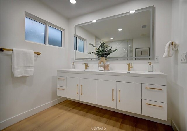 bathroom featuring a shower, wood-type flooring, and vanity