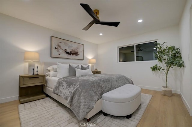 bedroom with ceiling fan, light wood finished floors, recessed lighting, and baseboards