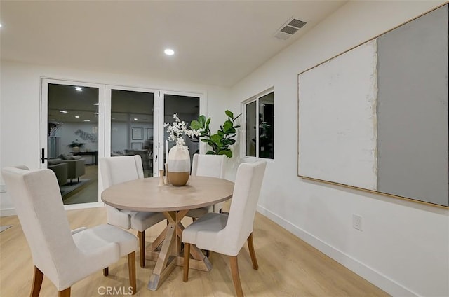 dining space with baseboards, recessed lighting, visible vents, and light wood-style floors