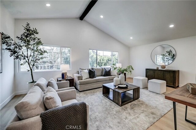 living room featuring light hardwood / wood-style flooring and lofted ceiling with beams