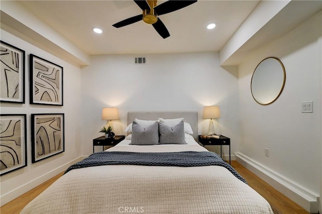 bedroom with ceiling fan and hardwood / wood-style flooring