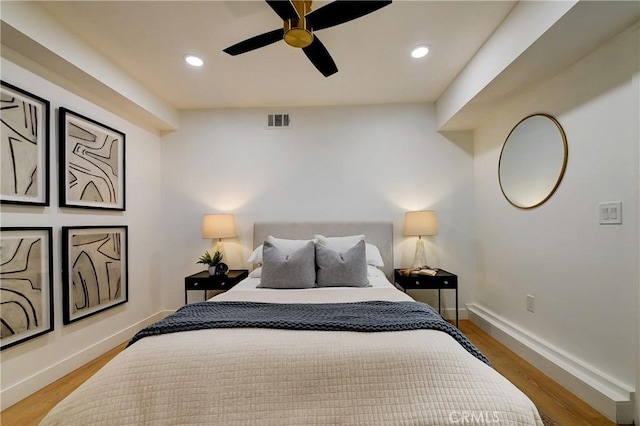 bedroom featuring recessed lighting, visible vents, baseboards, and wood finished floors