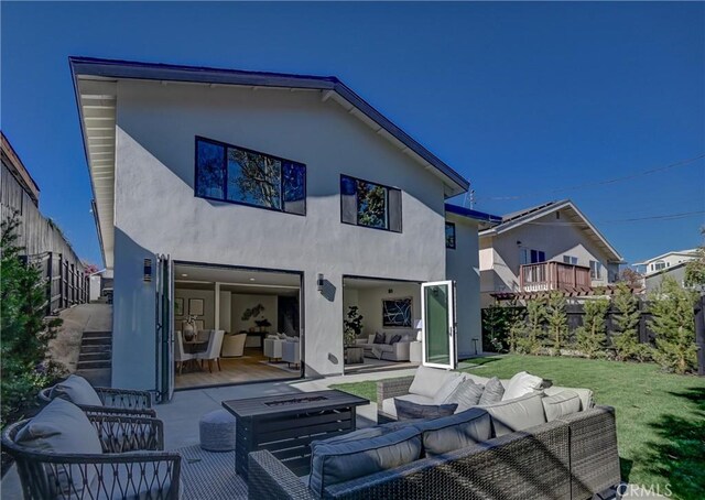 back of property featuring an outdoor living space, a lawn, and a patio