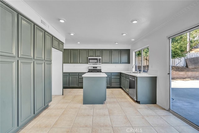 kitchen with a center island, light tile patterned flooring, sink, and stainless steel appliances