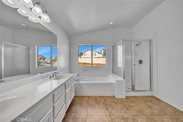 bathroom featuring tile patterned floors, vanity, a textured ceiling, shower with separate bathtub, and lofted ceiling