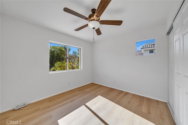 spare room with hardwood / wood-style floors and ceiling fan