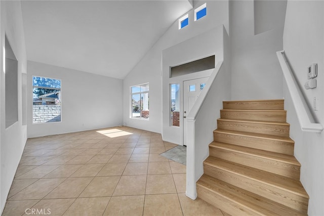 tiled foyer featuring lofted ceiling