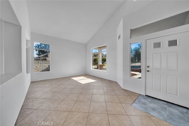 tiled foyer entrance with high vaulted ceiling