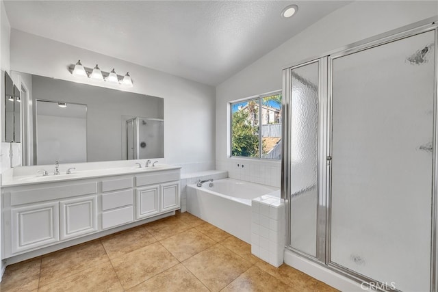 bathroom with plus walk in shower, tile patterned floors, a textured ceiling, lofted ceiling, and vanity