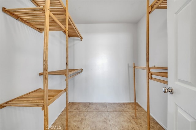 spacious closet with light tile patterned floors