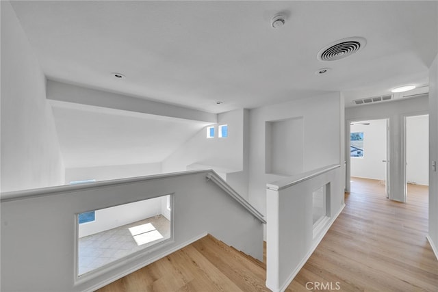 hallway with light hardwood / wood-style flooring