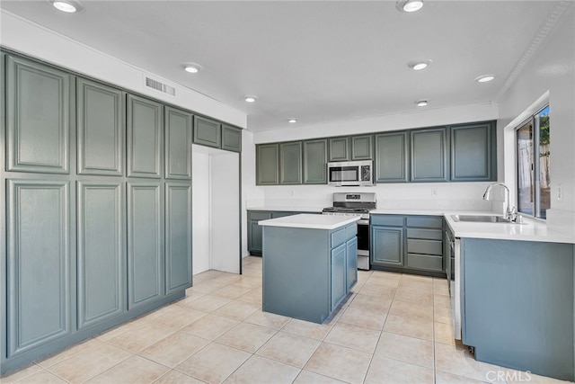 kitchen featuring a center island, sink, ornamental molding, light tile patterned flooring, and stainless steel appliances