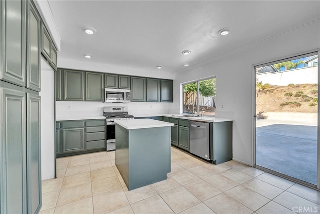 kitchen featuring appliances with stainless steel finishes, a center island, light tile patterned floors, and sink