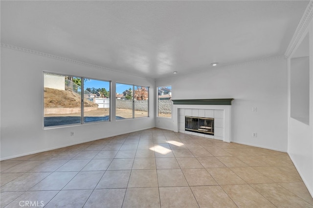 unfurnished living room featuring light tile patterned flooring, crown molding, and a fireplace