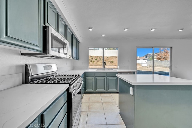 kitchen with sink, light tile patterned floors, and stainless steel appliances