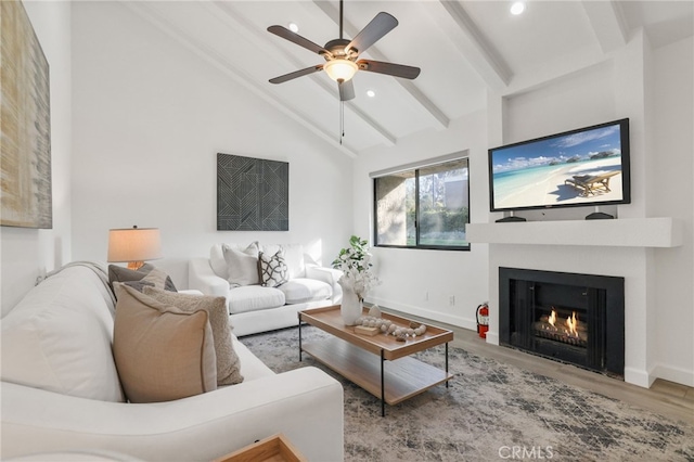 living room featuring wood-type flooring, vaulted ceiling with beams, and ceiling fan