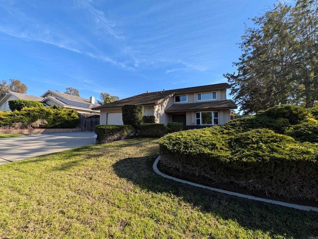 view of front of house featuring a front yard and a garage