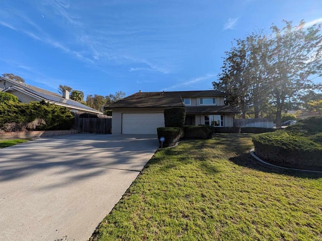 view of front of property with a garage and a front lawn