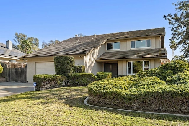 view of front of house with a garage and a front lawn