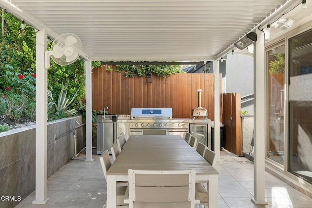 view of patio / terrace with a grill, sink, and an outdoor kitchen