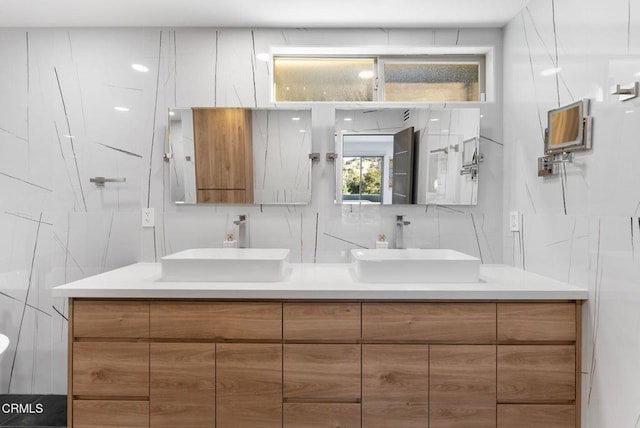 bathroom with tile walls, vanity, backsplash, and a shower