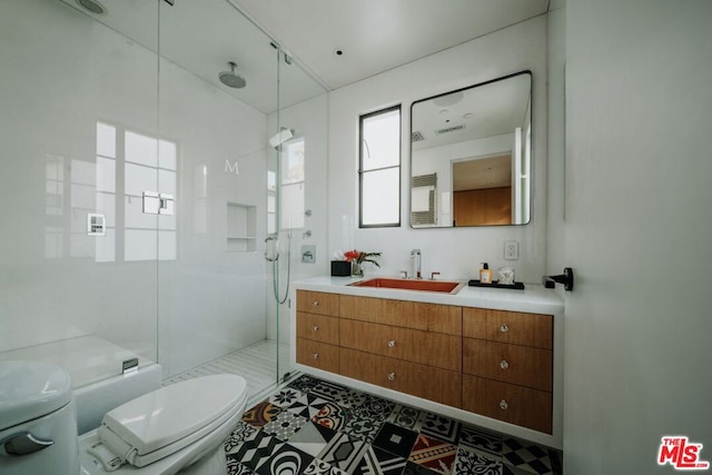 bathroom featuring an enclosed shower, vanity, and toilet