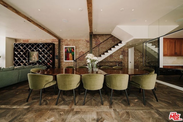 dining room featuring brick wall