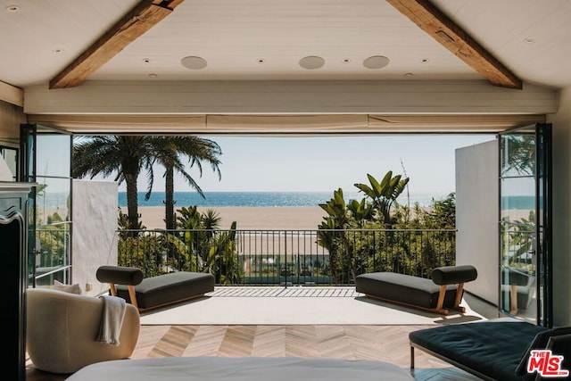 interior space featuring a water view and beamed ceiling