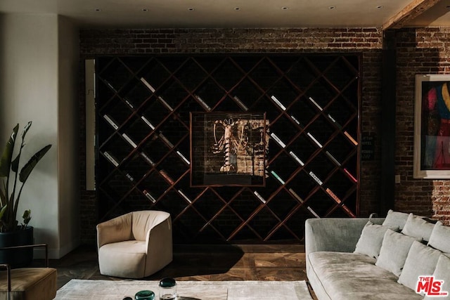 wine area featuring brick wall