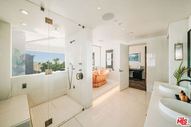 bathroom with tile patterned flooring, vanity, and a shower with door