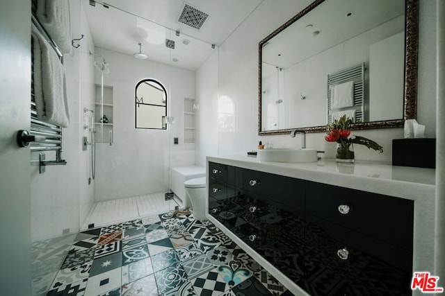 bathroom featuring an enclosed shower, vanity, tile patterned floors, and toilet