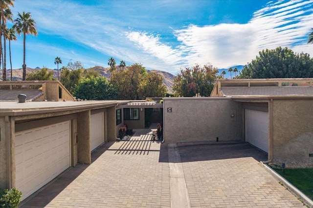 view of patio featuring a mountain view and a garage