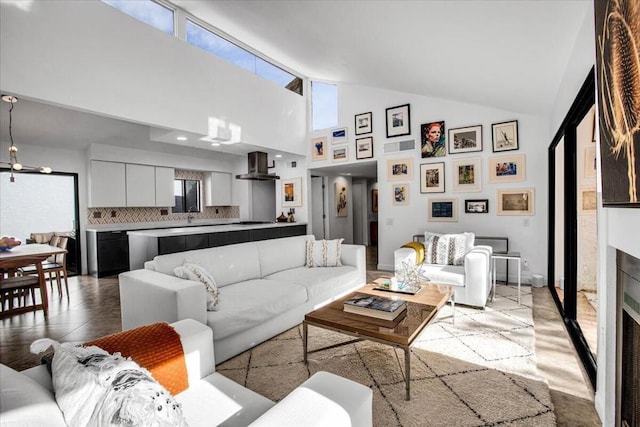 living room featuring high vaulted ceiling and plenty of natural light