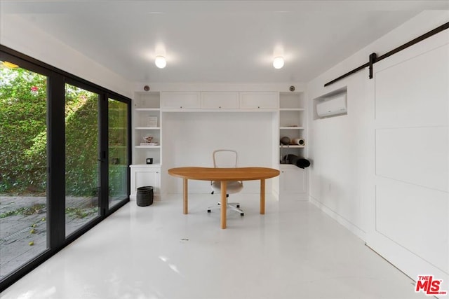 interior space with a barn door and concrete floors