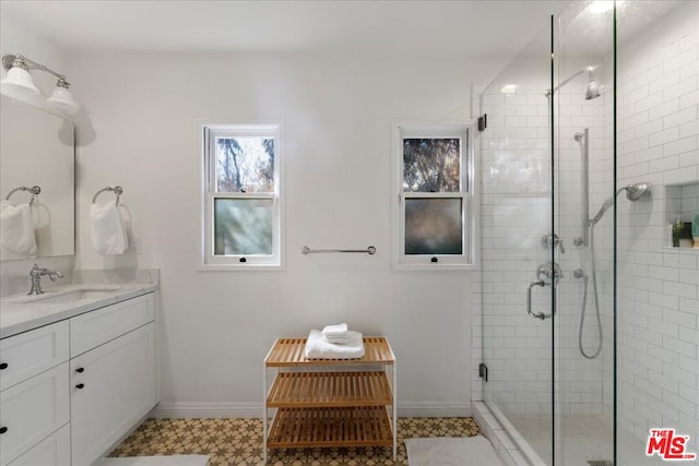 bathroom featuring vanity and an enclosed shower