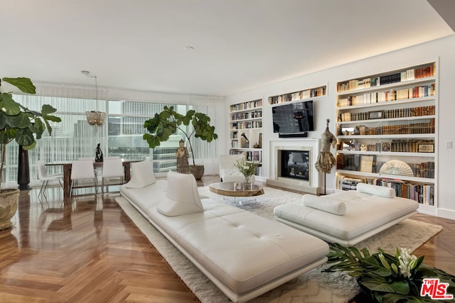 living room with built in features and parquet floors