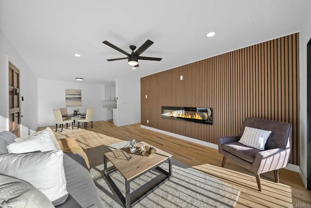 living room featuring ceiling fan and light wood-type flooring