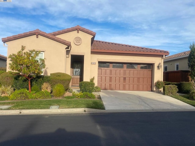 mediterranean / spanish-style house with a garage