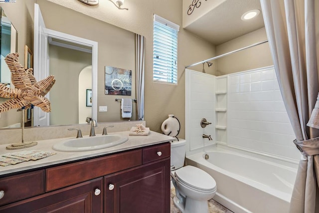 full bathroom featuring toilet, shower / bath combo, and vanity