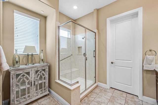 bathroom featuring an enclosed shower and tile patterned floors