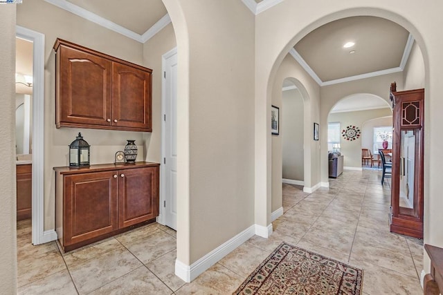 corridor featuring ornamental molding and light tile patterned flooring