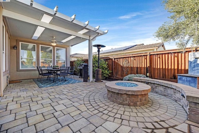 view of patio with a fire pit, grilling area, and ceiling fan