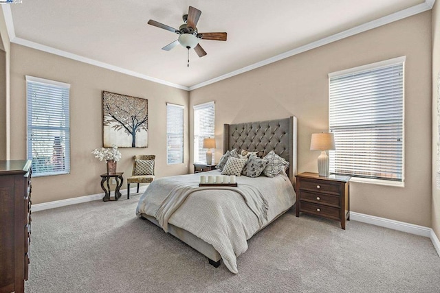 carpeted bedroom with ceiling fan and ornamental molding