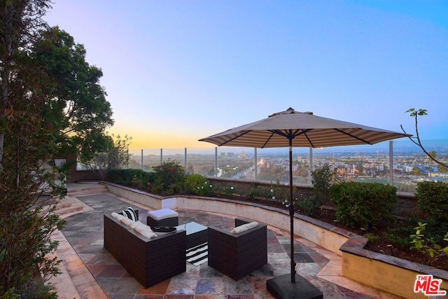 patio terrace at dusk featuring outdoor lounge area