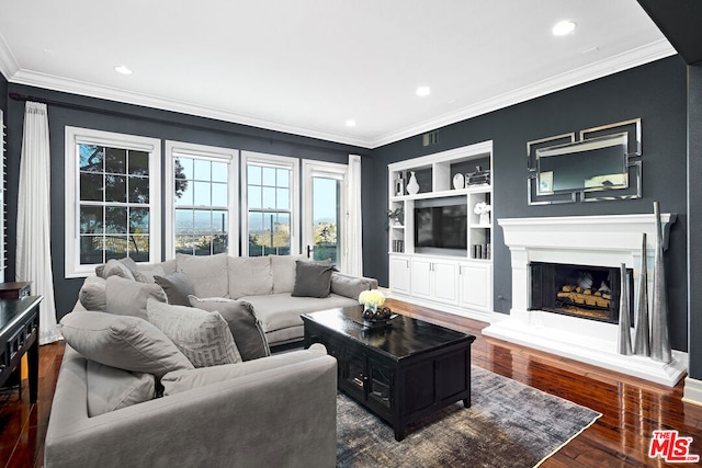 living room with built in shelves, dark hardwood / wood-style flooring, and ornamental molding