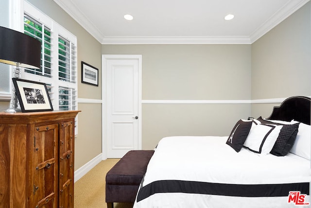 bedroom with light colored carpet and crown molding