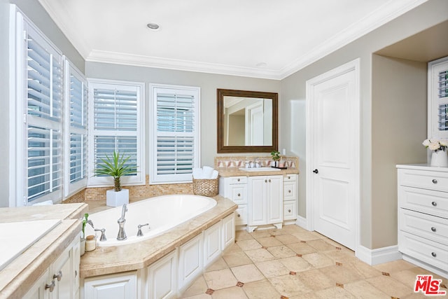 bathroom featuring a bathing tub, vanity, and ornamental molding