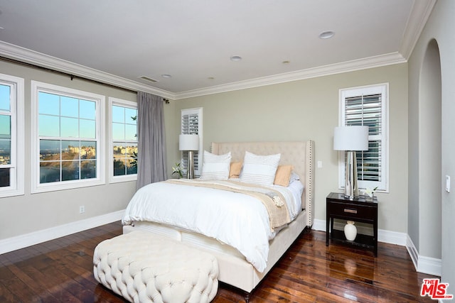 bedroom with ornamental molding and dark wood-type flooring